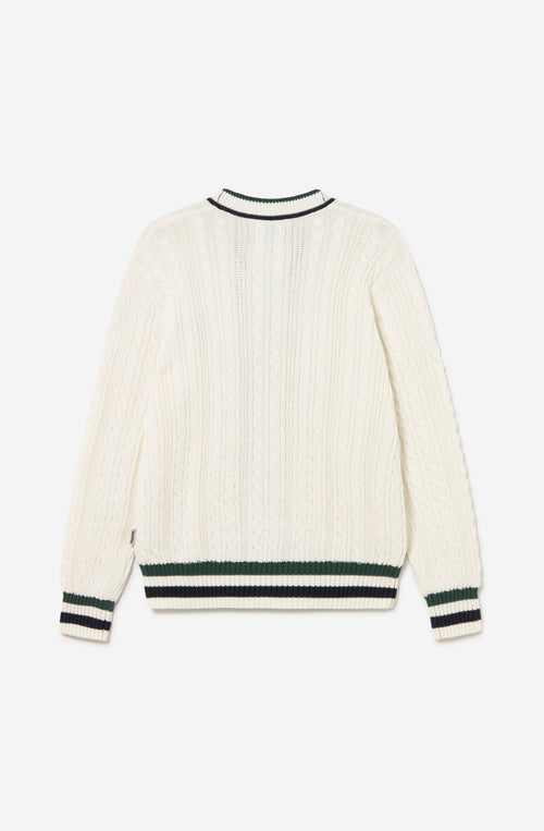 Cardigan de punto trenzado color marfil con cuello de pico, botones y detalles en verde y azul marino.