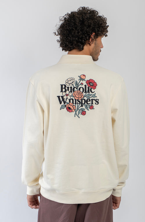 Sudadera zipper ivory con cuello polo, logo Bucolic Whispers en el pecho y bordado floral en la espalda.