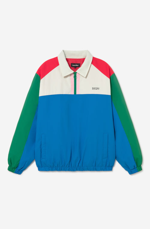 Chaqueta Kangaroo color block azul, verde, rojo y marfil con media cremallera y logo Kaotiko Society.