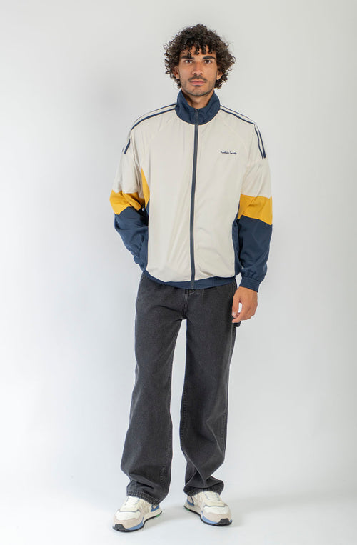 Chaqueta Retro Ski en marfil, vanilla y azul marino con diseño color block, cremallera a contraste y logo Kaotiko Society.