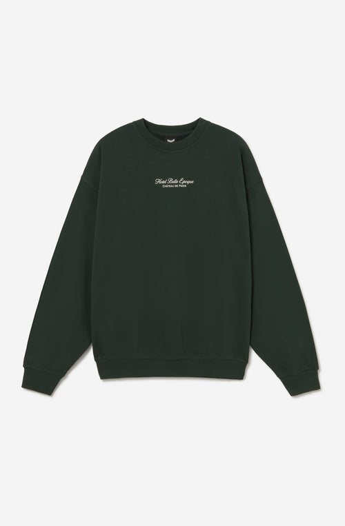 Sudadera oversize unisex verde con ilustración floral vintage en la espalda.