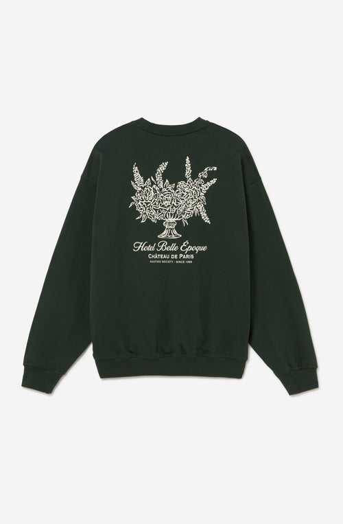 Sudadera oversize unisex verde con ilustración floral vintage en la espalda.