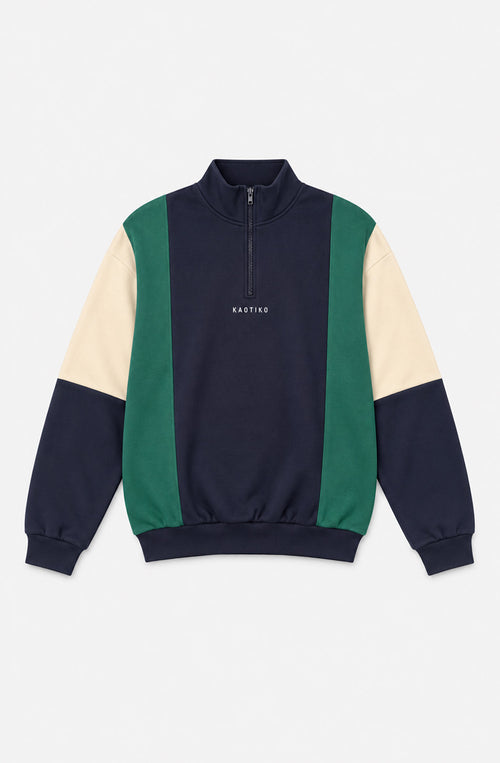 Sudadera unisex Tupoc azul marino con paneles verdes y crudos, cuello alto con media cremallera y logo Kaotiko en el pecho.